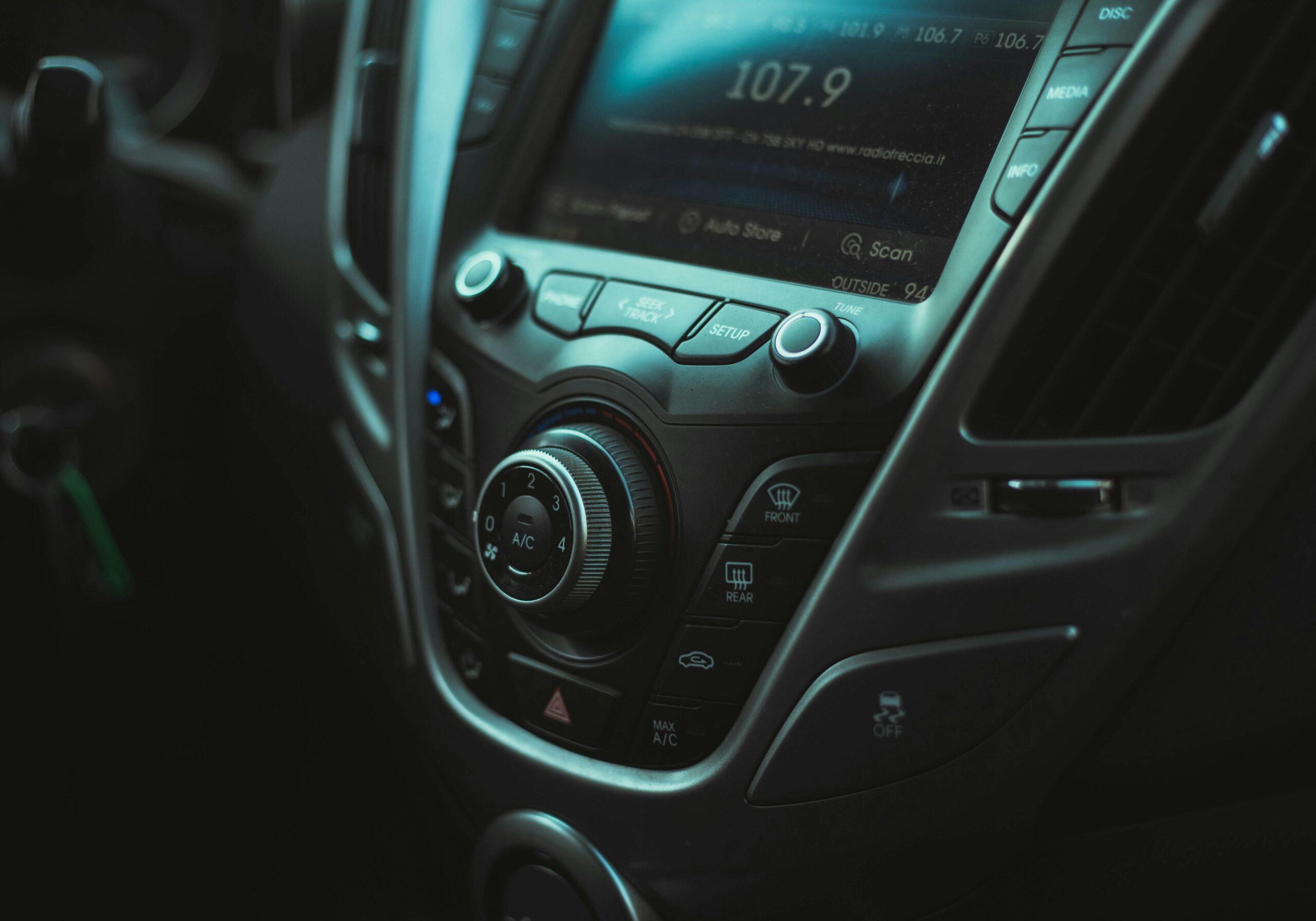 Detailed image of a car's dashboard with visible controls and air vent.